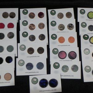 This is a pair of hand-made earrings with felted material details.